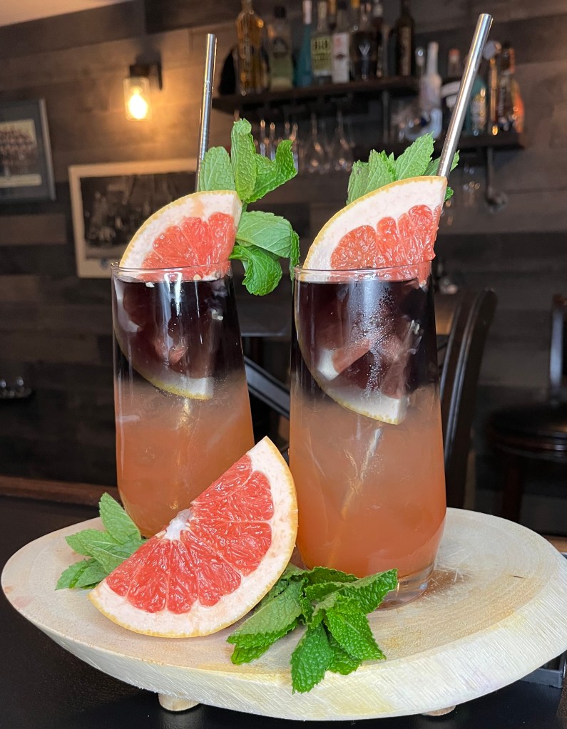 Meet the goth Paloma’s prettier Vodka twin! These stunning charcoal-to-coral layered cocktails are giving major sunset-in-a-glass vibes. Fresh-squeezed grapefruit, premium Black Vodka kissed with a touch of lime, and a minty crown come together for a drink that’s equal parts mysterious and refreshing. Garnished with juicy grapefruit wheels and served with eco-friendly metal straws – because even moody drinks deserve to look this good

