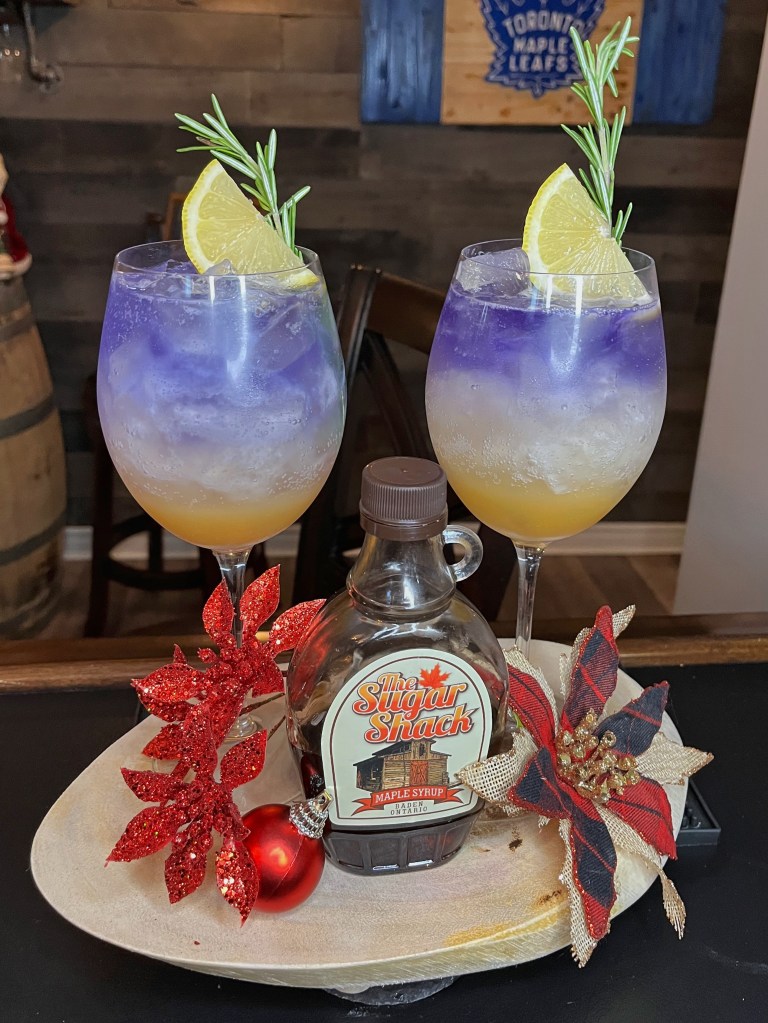 A beautiful vibrant artesan cocktail featuring gold and purple layers.  A perfectly balanced cocktail featuring maple syrup - off the charts delicious!!