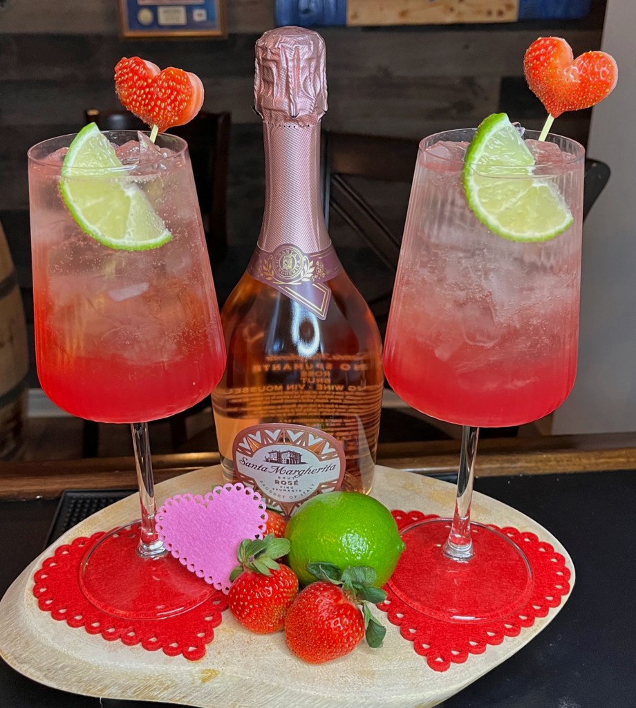 Romantic Rosa Linda Cocktail for Valentine's Day: pink Prosecco Rosé spritz with strawberry puree, tequila, and fresh lime, finished with a cute heart-shaped strawberry garnish