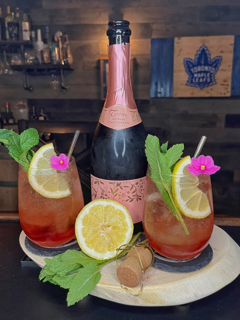 Light and refreshing Mother's Day cocktail in a stemmed wine glass. The sparkling pink drink is made with Campari, sweet vermouth, fresh lemon juice, and brut rosé sparkling wine, garnished with a lemon wheel and served over ice.

