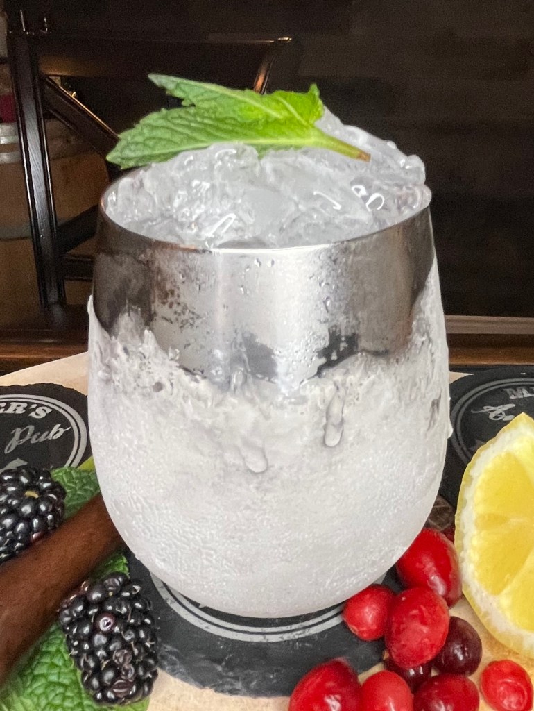 Classic Mint Julep: refreshing bourbon cocktail with fresh mint, simple syrup, and crushed ice, served in a frosty silver cup. Iconic Kentucky Derby drink.

