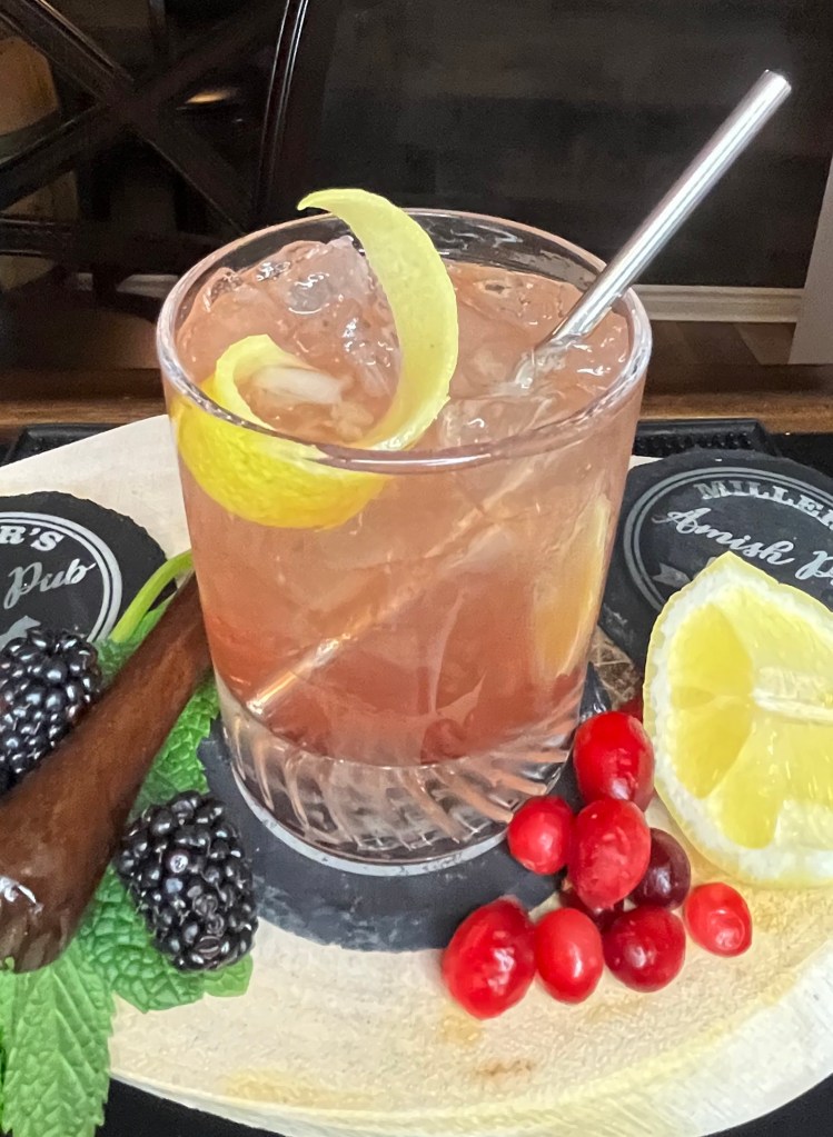A refreshing Kentucky classic featuring Woodford Reserve bourbon, zesty lemonade, and a splash of cranberry juice. This light, pink-hued cocktail delivers bright citrus notes balanced by smooth bourbon warmth and a hint of tart berry—perfect for Derby day or any sunny celebration. Served over ice with a lemon twist

